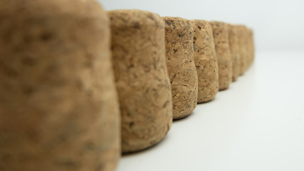 Row of wine corks with shallow depth of field. Focus in mid frame.