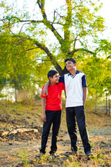 Naklejka premium two little indian brother walking on road