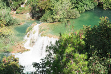 Fototapeta na wymiar Breathtaking view Waterfalls of Krka National Park, Sunny day, summer season having greenery and trees, Croatia