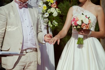 Wedding ceremony, groom and bride show hands with rings. Newlyweds couple