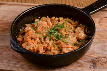 Vegetable and meat stew served in a pan over rustic wooden background table. Ukranian Traditional cuisine.