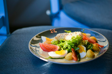Tasty healthy breakfast with carpaccio meat, boiled eggs, corn, tomatoes and fresh salad. Healthy food.