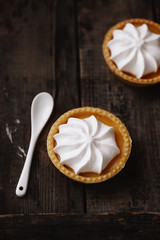 lemon cheesecake pie on wooden background with flower petals