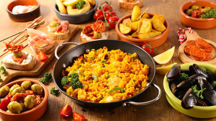 assorted of spanish dish- paella, tapas, olive, patatas bravas