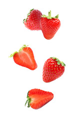 Set with falling sweet strawberries on white background