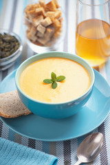 cream of pumpkin soup with bread.