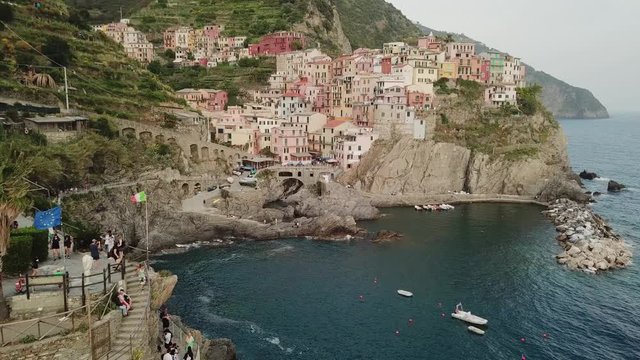 Drone shot of beautiful Italian old town with colorful houses near the sea in sunny day