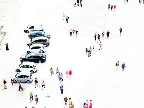 High Angle View Of People Walking On Snow Covered Field