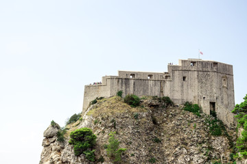 Fototapeta premium Dubrovnik old town city view, old castle view, Ancient fortress view and houses, a castle on the sea bay, hand made walls build with old bricks and stones, Croatia