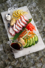 octopus sashimi, cucumber, lemon