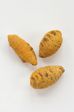 whole turmeric on a white background