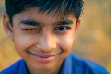 Portrait of beautiful winking little boy