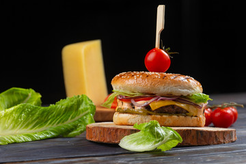 classic burger with salad, tomatoes, onion rings, cheese