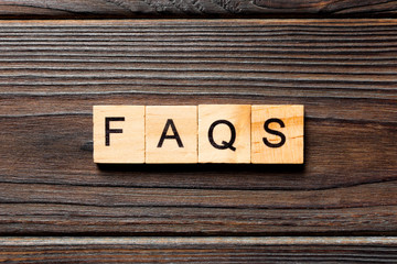 faqs word written on wood block. faqs text on table, concept