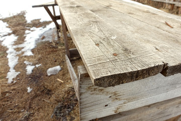 Old rusty nails driven into the Board, old wooden scaffolding. Wooden background, closeup with blur.