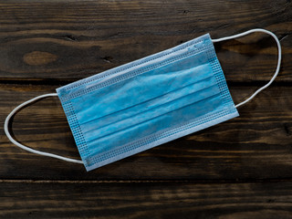 Medical mask on a wooden background. Medical equipment.