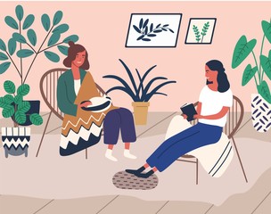 Two happy girl friend relax at home surrounded by houseplant vector flat illustration. Woman read book talking, smiling with female hold cat. People spend time together at cozy domestic interior