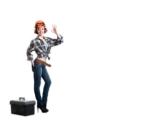Girl in a construction helmet, noise-insulating headphones with a tool box
