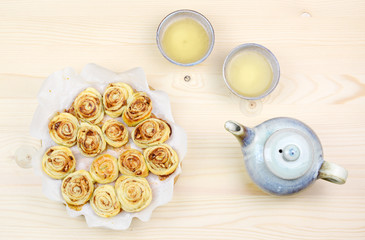 Homemade puff pastry cinnamon rolls served with green tea as breakfast, Czech republic, Europe.