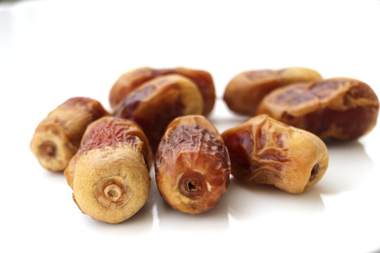dried dates isolated with pure drinking water on white background 