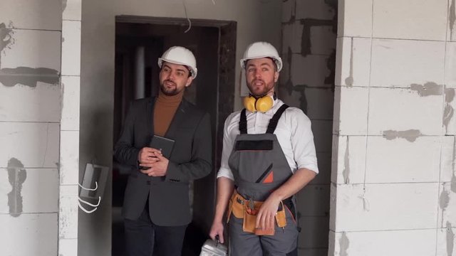 The foreman shows the client the work done on the construction