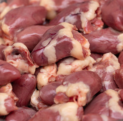 fresh chicken hearts as background