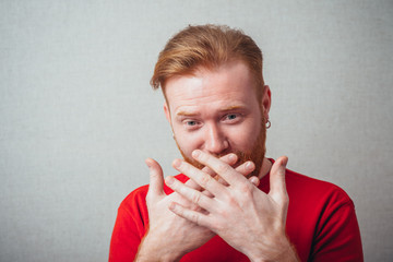 A young man holding back vulgar jokes