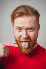 young man with finger in tongue