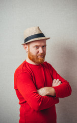 Portrait of handsome serious redhead man in hat