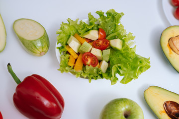 Bell pepper, apple, zucchini, avocado, vegetable salad on a white background, close-up. Concept of healthy eating.