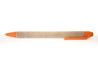 Recycled, biodegradable cardboard pen with push button and orange clip isolated on white background. Ecological pen ideal to personalize with company name or logo.