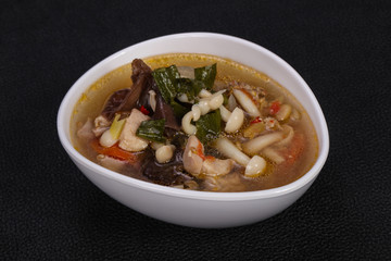 Thai style soup with meat and mushrooms