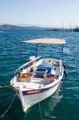 Obraz premium A small white fishing boat in the sea in Greece