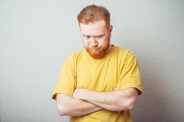 bearded man offended and folded his hands