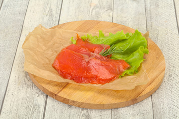 Sliced salmon fillet served rosemary