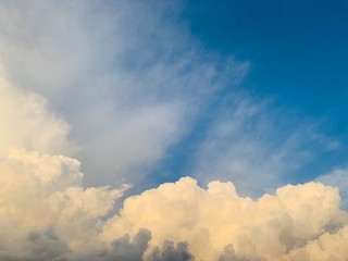white cumulus clouds against deep blue sky