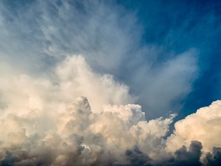 white cumulus clouds against deep blue sky
