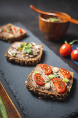 Homemade Rustic Pate on Bitten Slice of Bread with Fresh Vegetables