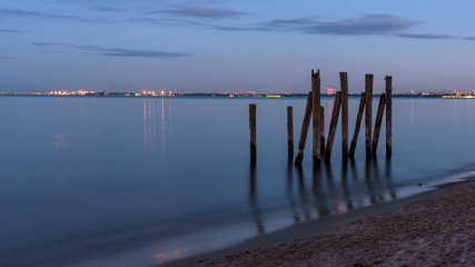 Fototapeta premium Wooden piles in the Gulf of Gdansk in Poland at dusk