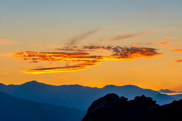 Golden Post-Sunset Sky Over the Mountain Peaks