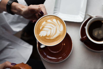 Young woman enjoying a cup of coffee, view from above