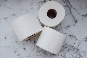 Toilet paper, 3 rolls are on the table, rolls of toilet paper
