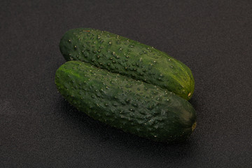 Green fresh cucumbers over background