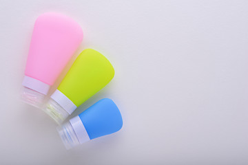 three colored tubes on white background with copy space