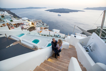 Obraz premium Romantic couple posing together on stairs of a beautiful city