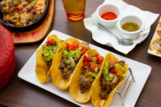 Mexican food tasty tacos with beef, guacamole sauce
