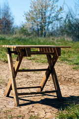 Small used folding chair, on cracked land in nature