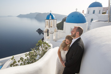 Wedding couple up the stairs of the streets of Santorini.