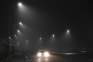 quarantine isolation, night street in the fog, no people, one rides a car, a light misty horror