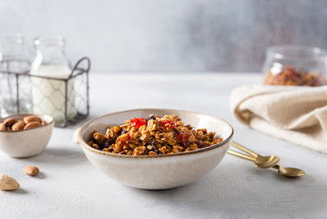 Organic homemade Granola Cereal with oats and walnuts. Oatmeal granola or muesli in bowl. Side view, Copy space. Dieting